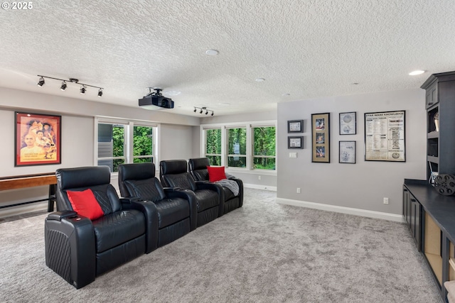carpeted home theater room with baseboards, a textured ceiling, and a healthy amount of sunlight