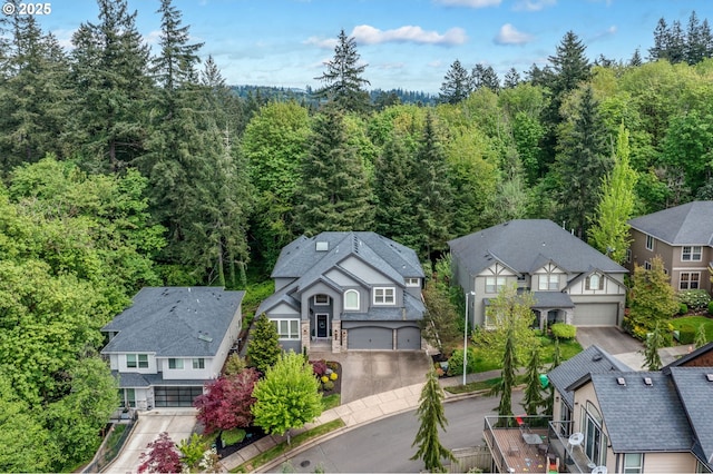 birds eye view of property featuring a forest view and a residential view