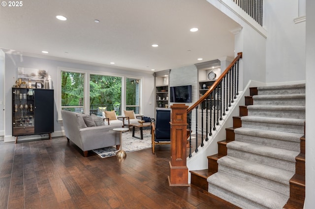 living area with wood-type flooring, baseboards, stairway, recessed lighting, and a dry bar