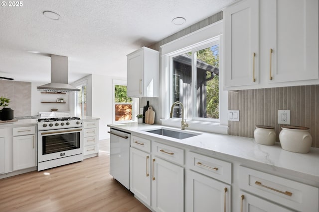 8616 SW 49th Ave, Portland, OR 97219 - kitchen with white range with gas stovetop, island range hood, dishwasher, a sink, and white cabinets
