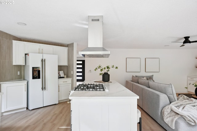 8616 SW 49th Ave, Portland, OR 97219 - kitchen with white refrigerator with ice dispenser, range hood, open floor plan, gas stovetop, and light wood finished floors