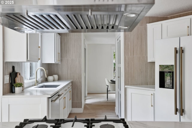 8616 SW 49th Ave, Portland, OR 97219 - kitchen featuring white refrigerator with ice dispenser, a sink, ventilation hood, light countertops, and white cabinetry