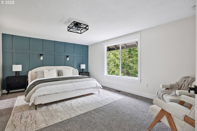 8616 SW 49th Ave, Portland, OR 97219 - carpeted bedroom featuring a decorative wall, a textured ceiling, and baseboards