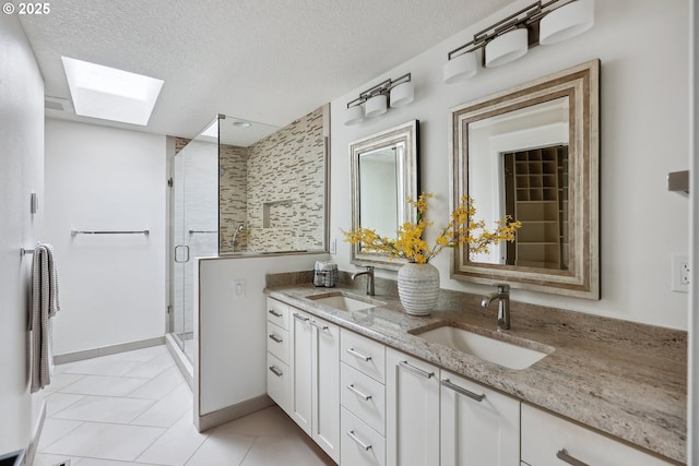 8616 SW 49th Ave, Portland, OR 97219 - full bath with a skylight, double vanity, a shower stall, a textured ceiling, and tile patterned flooring