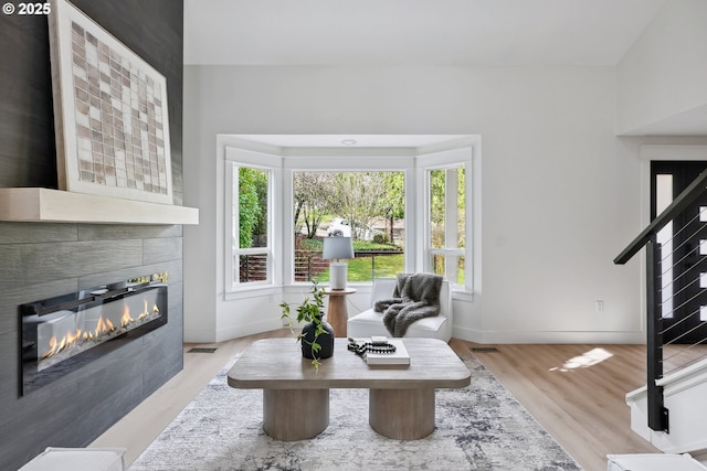 8616 SW 49th Ave, Portland, OR 97219 - living room featuring a fireplace, baseboards, and wood finished floors