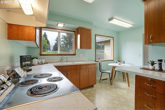 17725 NE Multnomah Dr, Portland, OR 97230 - kitchen featuring a sink, light countertops, range, brown cabinetry, and light flooring