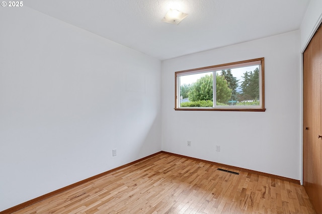 17725 NE Multnomah Dr, Portland, OR 97230 - unfurnished bedroom featuring light wood-style floors, baseboards, and a closet