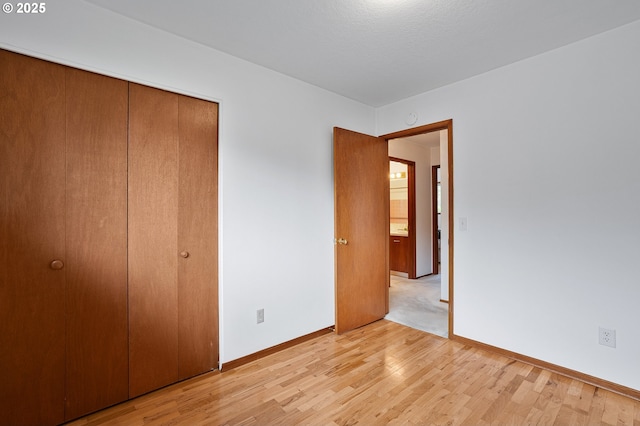 17725 NE Multnomah Dr, Portland, OR 97230 - unfurnished bedroom with light wood-type flooring, a closet, and baseboards