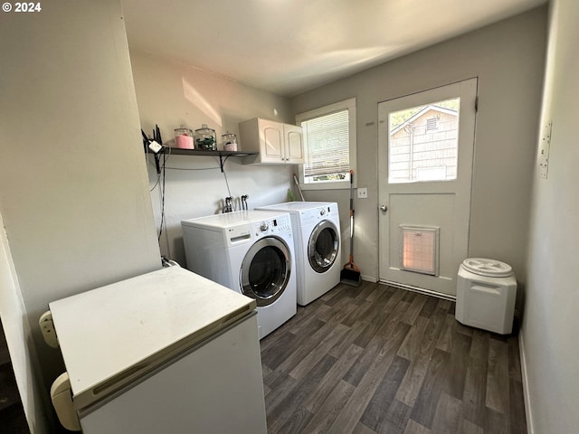 laundry room with cabinets, washer and dryer, and dark wood-type flooring