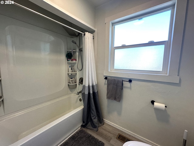 bathroom featuring shower / tub combo and hardwood / wood-style flooring