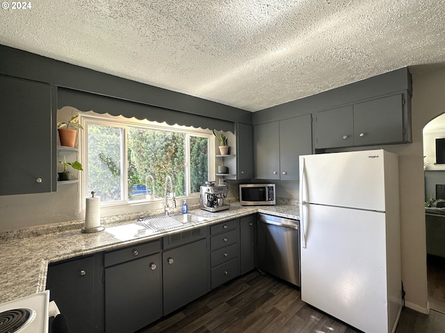 kitchen featuring gray cabinetry, sink, appliances with stainless steel finishes, and dark wood-type flooring