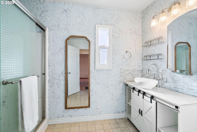 bathroom featuring vanity, baseboards, and tile patterned floors