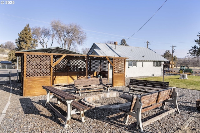 back of house featuring an exterior structure, metal roof, and an outdoor structure