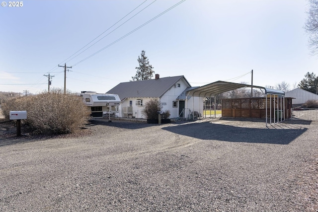 view of front of house with a carport and driveway