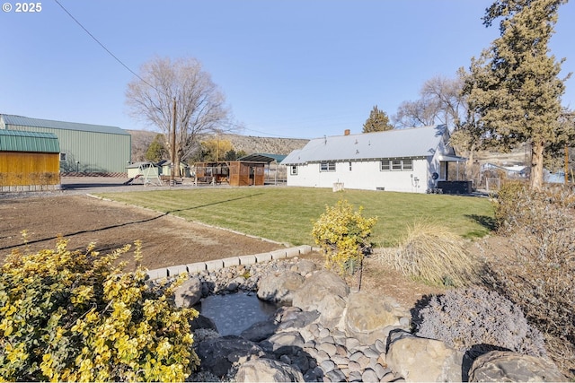 rear view of house featuring a lawn