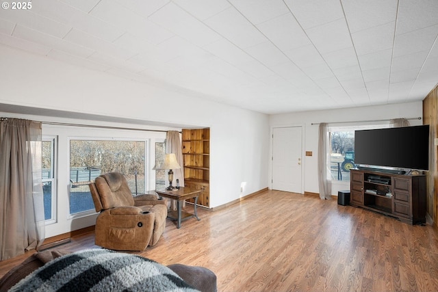 living room featuring baseboards and wood finished floors