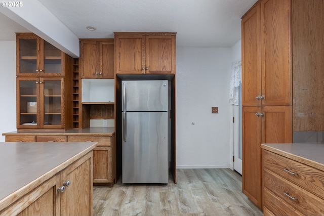 kitchen with stainless steel refrigerator and light wood-type flooring