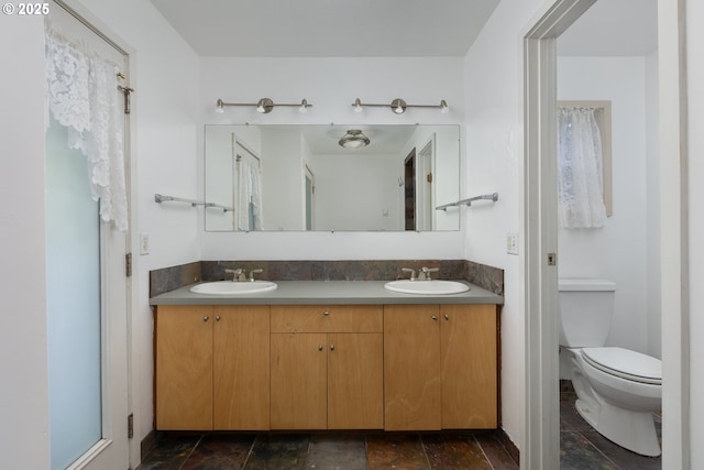 bathroom featuring vanity and toilet