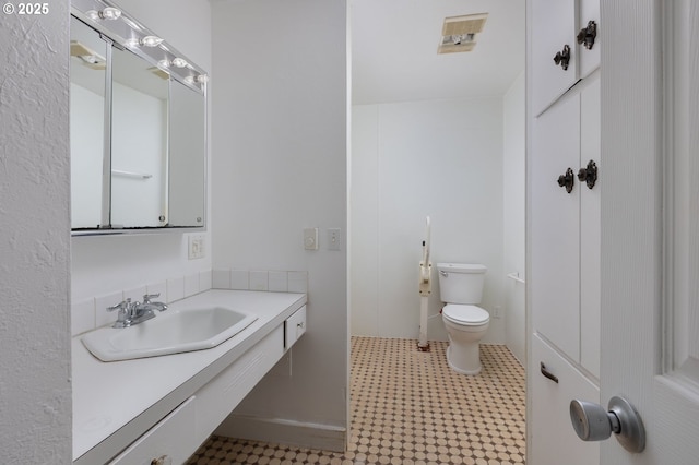 bathroom with sink and toilet