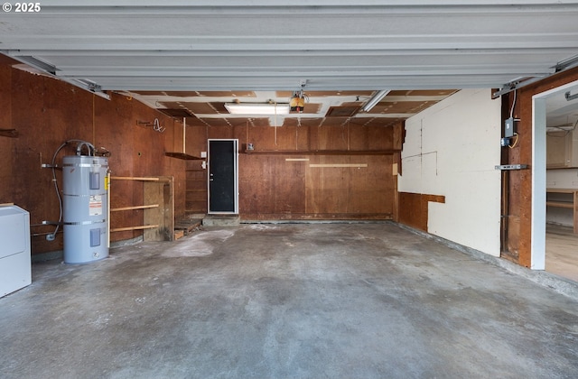 garage featuring wooden walls, a garage door opener, washer / clothes dryer, and water heater