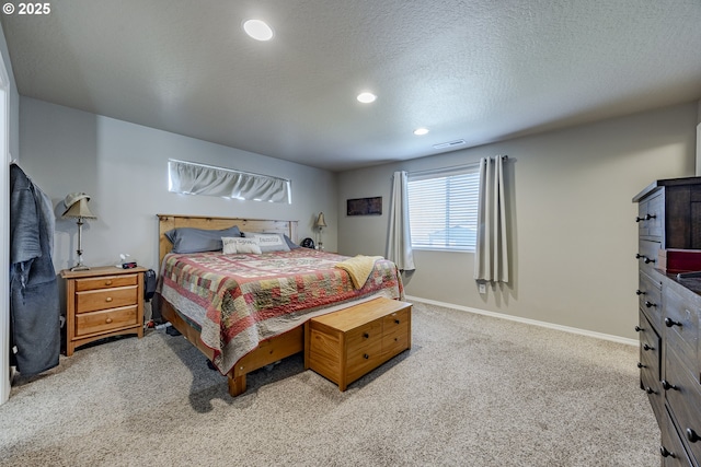 carpeted bedroom with a textured ceiling, recessed lighting, visible vents, and baseboards