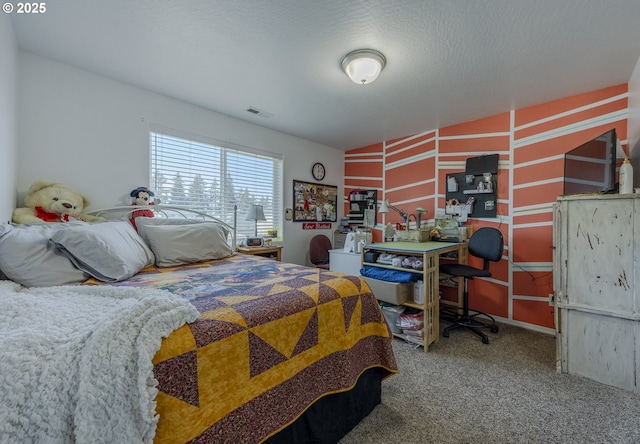 carpeted bedroom featuring a textured ceiling and visible vents