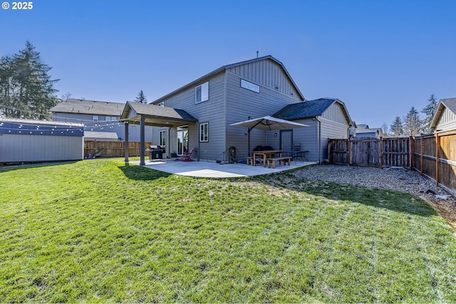 back of property featuring a yard, a fenced backyard, and a patio