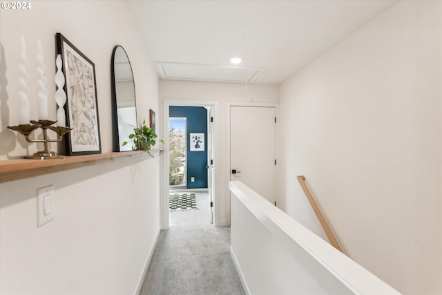 hallway featuring an upstairs landing, carpet flooring, attic access, and baseboards