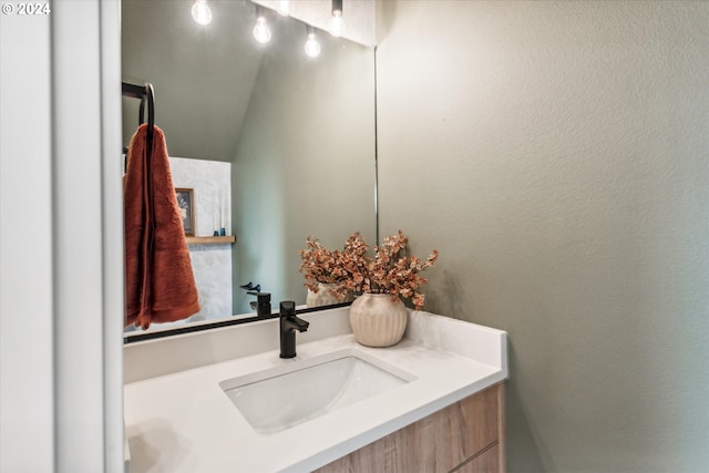 bathroom with vanity and a textured wall