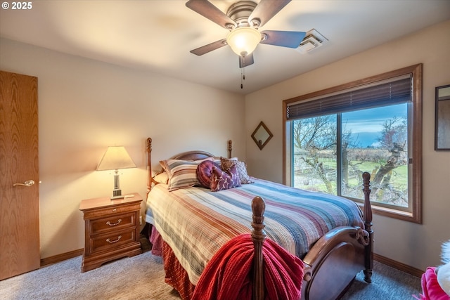 bedroom featuring light colored carpet, visible vents, baseboards, and a ceiling fan
