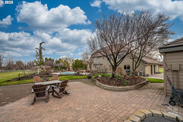 view of patio / terrace with fence, an outdoor pool, a garage, an outdoor fire pit, and cooling unit