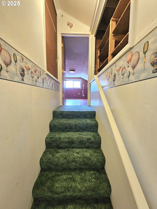 stairway with vaulted ceiling