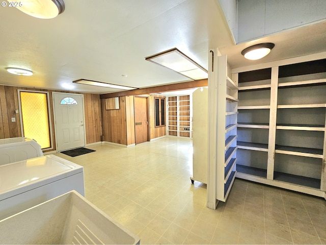 interior space featuring wooden walls and washer and dryer
