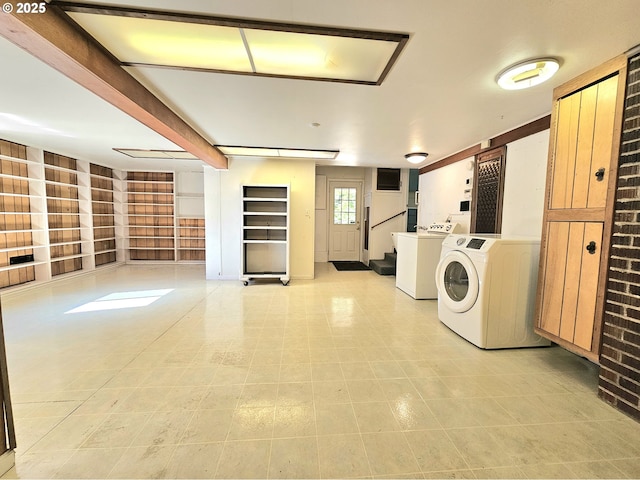 clothes washing area featuring built in shelves and washer and dryer