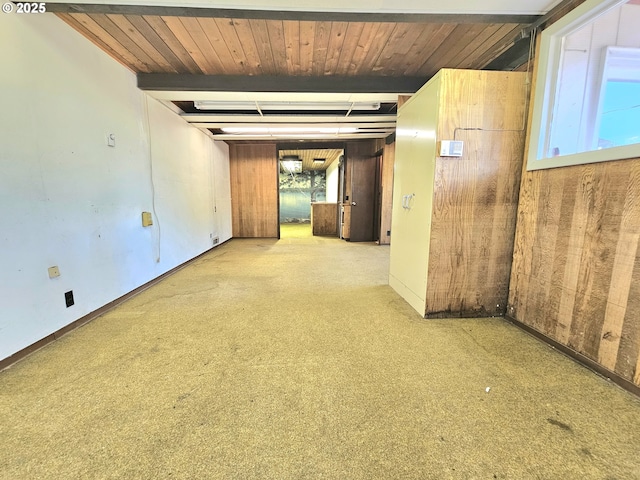 carpeted empty room featuring beamed ceiling