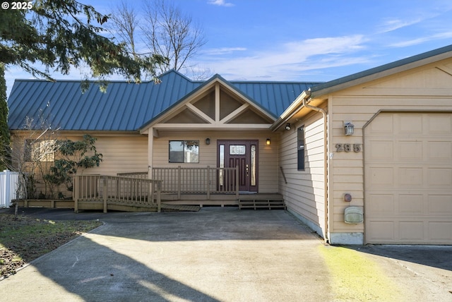 285 W Sunny Sands Rd, Cathlamet, WA 98612 - view of front of property with metal roof, a porch, and a garage
