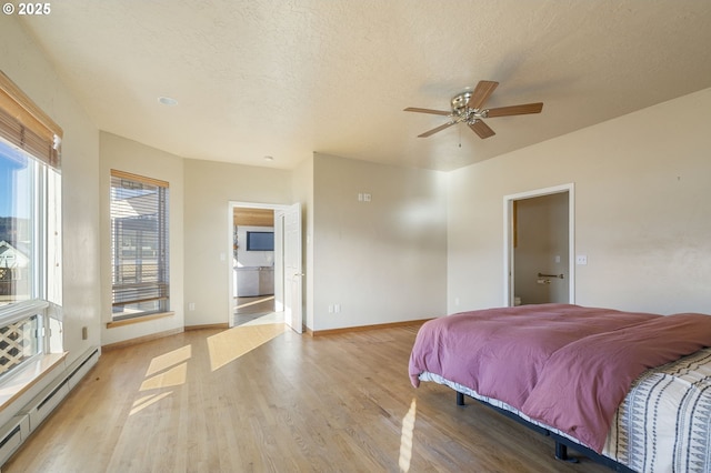 285 W Sunny Sands Rd, Cathlamet, WA 98612 - bedroom with a baseboard heating unit, light wood-style flooring, baseboards, and ensuite bath
