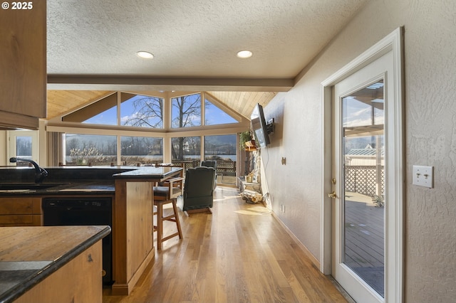 285 W Sunny Sands Rd, Cathlamet, WA 98612 - kitchen with a sink, wood finished floors, a textured ceiling, a textured wall, and dishwasher