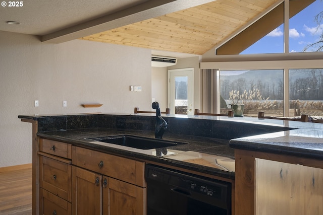 285 W Sunny Sands Rd, Cathlamet, WA 98612 - kitchen featuring black dishwasher, a sink, wood finished floors, dark stone countertops, and brown cabinetry