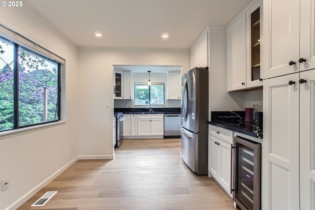2900 NW 111th Ct, Portland, OR 97229 - kitchen with visible vents, wine cooler, recessed lighting, white cabinets, and appliances with stainless steel finishes