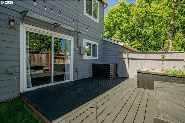 wooden terrace featuring fence