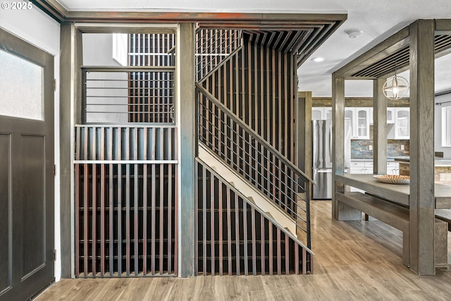 detailed view of wood finished floors and a smoke detector