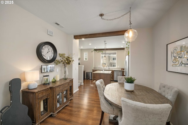 dining area featuring dark wood-style floors, beamed ceiling, visible vents, and recessed lighting