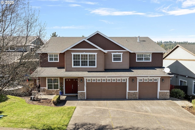 view of front of property with stone siding, roof with shingles, driveway, and an attached garage