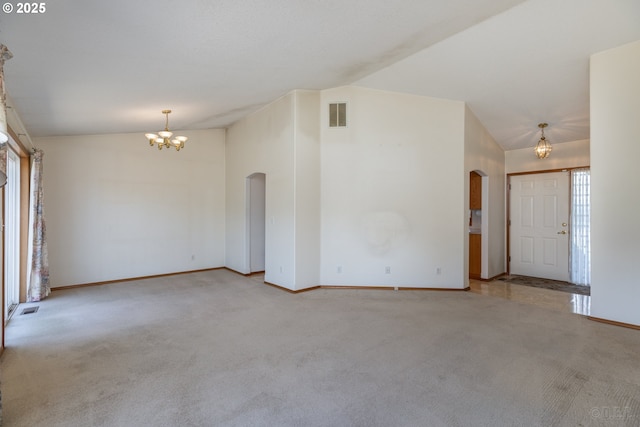 305 Pacific St, Columbia City, OR 97018 - carpeted spare room featuring arched walkways, lofted ceiling, a chandelier, and baseboards