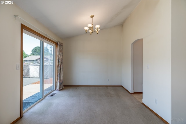 305 Pacific St, Columbia City, OR 97018 - empty room featuring arched walkways, carpet, a chandelier, vaulted ceiling, and baseboards