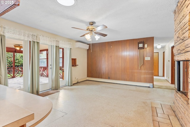 unfurnished living room featuring a textured ceiling, a wall unit AC, ceiling fan, and a baseboard radiator