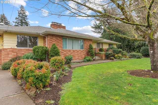 single story home with brick siding, a chimney, a front yard, and a shingled roof