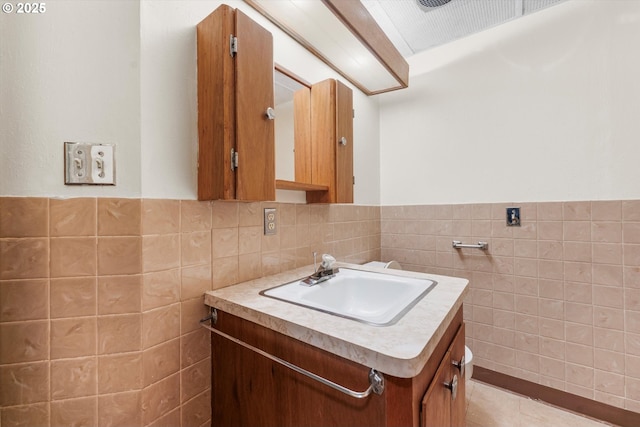 bathroom featuring a wainscoted wall, tile walls, and vanity