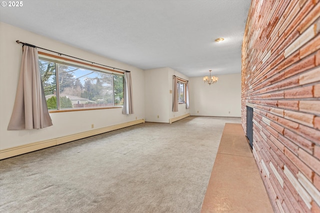 unfurnished living room with carpet, a textured ceiling, a brick fireplace, baseboard heating, and a chandelier